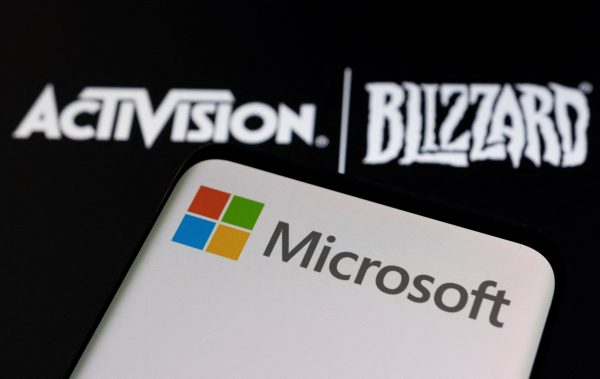 Microsoft agreement, Credit@ Microsoft logo is seen on a smartphone placed on displayed Activision Blizzard logo in this illustration taken January 18, 2022. REUTERS/Dado Ruvic/Illustration